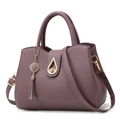 Purple lychee grain tote bag with gold teardrop lock and elegant side tassel detail - Purple