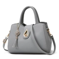Light gray lychee pattern tote bag with golden hardware and tassel charm on white background - Light Gray