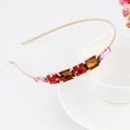 Golden metal headband with geometric red and pink crystals on white ceramic background - Style 05 Gold