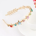 Gold star and leaf metal headband featuring multi-colored rhinestones on white cup - Star-Gold