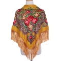 Close-up of ethnic yellow shawl with red floral print, paisley patterns and fringe detail - Turmeric
