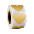 Macro detail of heart-shaped gold and silver scratch-off adhesive stickers on a roll - Small Roll / Gold