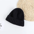 Close-up of black knitted beanie showing thick textured wool material and folded brim detail - 52-58cm / Black