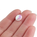 Macro detail of a 10mm white resin mermaid scale cabochon held on a fingertip for DIY crafts - Translucent White(15)