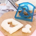 Blue dog and house shaped sandwich cutter on a wooden board with bread slices - Dog-Blue