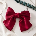 Close-up of a large wine red satin bow hair clip on a minimalist white background - Spring Clips / Burgundy