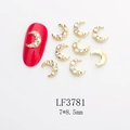 Macro view of gold moon nail charm with aurora rhinestones on red manicure, size 7x8.5mm - Gold Aurora Crescent (LF3781)