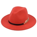 Detail of red wool fedora hat featuring a black leather band and golden leaf metal ornament - Orange