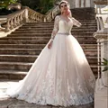 Elegante trouwjurk met lange mouwen van kant met champagne A-lijn rok en ceintuur - US 2 / Ivoor