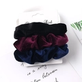 Detailed view of velvet scrunchies set in black, burgundy and navy on display card - Velvet Black Wine Red Navy 3-Pack