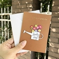 Brown greeting card with floral watering can design and lovely day text in hand - S-Style Watering Can