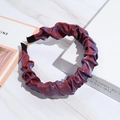 Iridescent purple and blue pleated fabric headband on a white marble surface - Violet Blue
