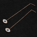 Rose gold threader earrings with crystal evil eye pendant on black textured surface - Evil Eye (8318)