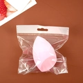 Pink teardrop makeup sponge sponge in transparent plastic packaging on brown background - Beveled Shape (Individual Bag) / Pink
