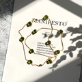 Long gold chain necklace featuring ten green cushion-cut crystal gemstones in a row - Gold + Grass Green