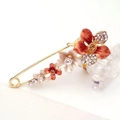 Large floral safety pin brooch in gold finish with orange and cream crystal petals - Champagne Bauhinia