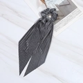 Silver grey pleated fabric long tassel bow hair scrunchie on marble background - Gray