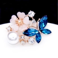 Elegant gold flower and blue butterfly brooch with pink petals and white pearl details - Blue Butterfly Flower