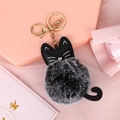 Portachiavi gatto creativo in ecopelle nera e pompon grigio su sfondo rosa con biglietto - Nero Bicolore
