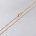 Close-up of a golden stainless steel ball bead chain with a secure lobster clasp - Gold / 45cm