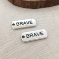 Set of two silver rectangular metal tags featuring Brave engraving for DIY jewelry - Brave