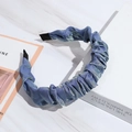 Elegant blue pleated headband with metallic luster on white marble and book background - Light Blue