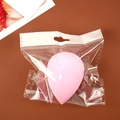 Pink teardrop makeup sponge blender in transparent hanging bag on brown surface - Waterdrop Shape (Individual Bag) / Pink