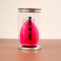 Pink teardrop makeup puff sponge in clear cylindrical packaging labeled MAKE UP PUFF - Beveled Shape (Cylinder Pack) / Rose Red