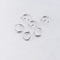 Macro view of polished silver stainless steel jump rings for DIY jewelry making - Steel
