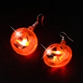 Glowing orange LED pumpkin earrings for Halloween party with silver hooks on dark background - Pumpkin Hook Style / Orange