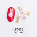 Detailed view of pink pearl rabbit ear nail art charm with rhinestones on a red nail - 5054 Light Pink Pearl Dynamic Rabbit Style