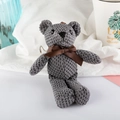Gray knitted bear plush keychain with a brown ribbon bow and metal clasp - Dark Gray