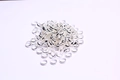 Close-up of bulk silver-plated metal beads and round spacer rings for jewelry making - Outer Diameter 12mm / Silver