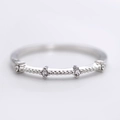 Detailed close-up of a silver ring featuring four small zircons with beaded edge craftsmanship - US 6 / Silver