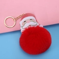 Christmas keychain featuring large red faux fur pompom and Santa Claus leather charm - Ring Clasp Style