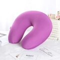 Detail of purple U-shaped travel neck pillow with soft velvet texture on plush surface - Purple