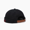 Detail of black cotton docker hat featuring red helm embroidery and brown leather strap - Solid Black Helm Embroidery