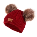 Detailed view of red knitted baby hat featuring dual faux fur pom-poms and leather patch - Burgundy Hat (Brown Pom Pom)