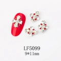Macro detail of 9x11mm 3D butterfly nail art charm with silver alloy and red rhinestones - 5099 Iridescent White + White
