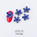 Macro detail of blue crystal 5-petal flower nail charms with gold metal base - 5112 Royal Blue