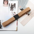 Detail of khaki elastic woven belt with black buckle on a fashion magazine background - Plastic Buckle (Khaki)