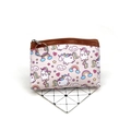 Close-up of unicorn coin purse featuring a round metal keychain and leather piping - All-over Cartoon Unicorn (No.7)