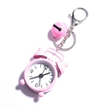 Detailed view of a pink mini alarm clock keychain with a small matching bell and ring - Pink