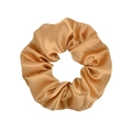 Detailed view of champagne gold satin scrunchie showing silky texture and elastic folds - Champagne Gold