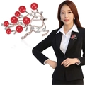 Rose gold reindeer brooch with red pearls and diamonds on a black suit lapel - No. 23-Rose Gold Red Pearl Reindeer