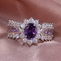 Elegant silver ring featuring oval purple gemstone with floral halo and side stones - US 6 / Purple