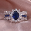 Glamorous silver ring with oval blue zircon center and multi-layer flower setting - US 6 / Dark Blue