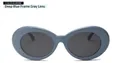Detail view of dark blue oval frame sunglasses with grey lenses on a white background - Dark Blue Frame Grey Lens