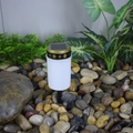 Solar powered white cemetery light with golden cross patterns on pebble ground - Cemetery Stake (White)