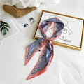 Contrast floral silk scarf in blue and orange peach tied in an elegant neckerchief knot - Grey Floral Edge